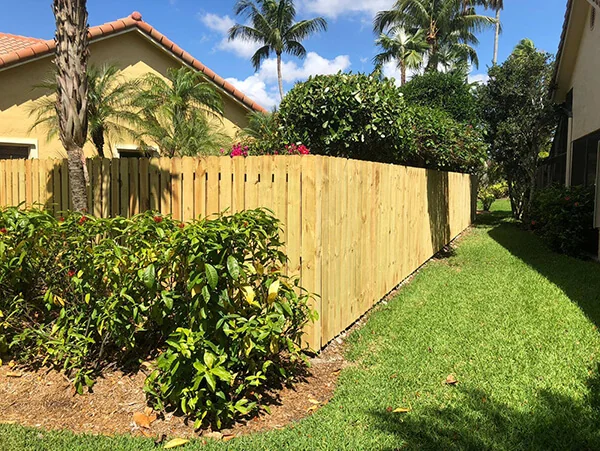 Wood privacy fence alongside a home